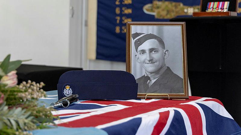 Flight Sergeant Gordan Hamilton's portrait displayed during the memorial service for four WWII RAAF servicemen at RAAF Base Amberley.