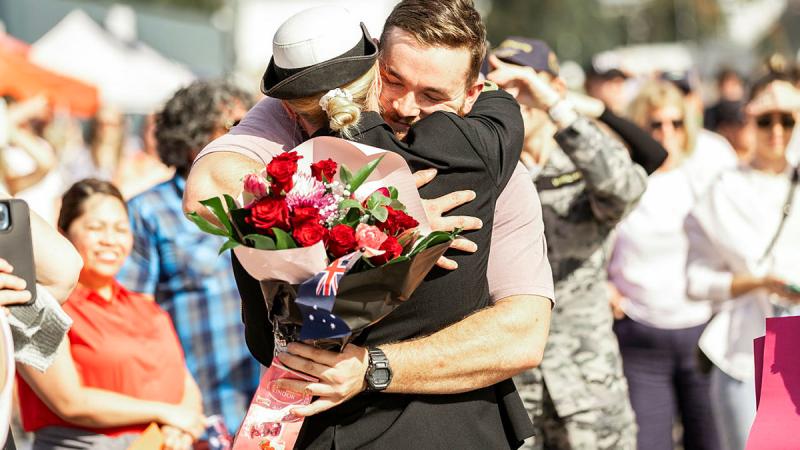 Lieutenant Rene Van Rooyen from HMAS Warramunga embraces her partner on the wharf of Fleet Base East, Sydney, on return from deployment.  