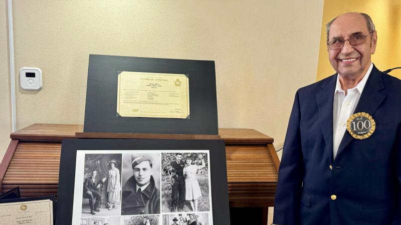 Former Flying Officer Sidney Mibus next to his service certificate, badge and WWII medals.