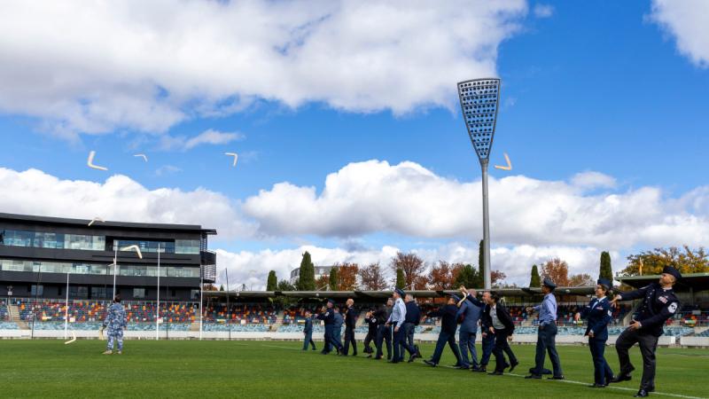 Senior international defence leaders participate in a boomerang-throwing activity during the Chiefs and SELT Conclave at Manuka Oval, Canberra, in the lead up to the Air and Space Power Conference. 
