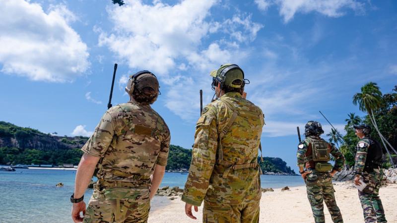 Joint terminal attack controller Bombardier Jackson Lawrence (right) alongside JTAC and Ground Forward Air Controllers (GFAC) from the UK and Malaysia call in close air support from a Republic of Singapore Air Force F-16 in the Tioman Island group, Malaysia during Exercise Bersama Shield 2024.