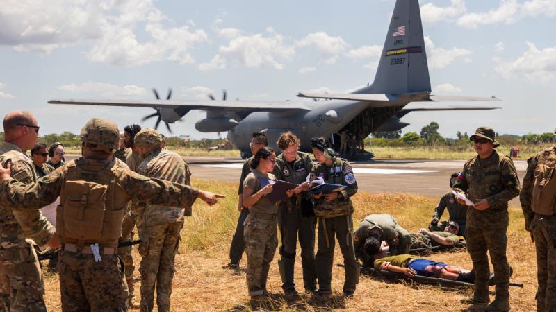 Personnel from the Royal Australian Air Force, Pacific Air Forces and the Armed Forces of the Philippines assess casualties at the site of a simulated aeromedical evacuation during Exercise Balikatan, Philippines.