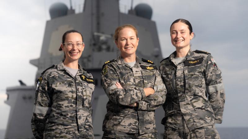 Mothers of HMAS Hobart, Petty Officer Amy Peters, left, Commanding Officer HMAS Hobart Commander Tina Brown and Leading Seaman Rochelle Hambly, stand on the forecastle as the ship conducts a regional presence deployment. 