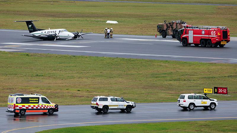  Emergency response vehicles arrive on scene to provide assistance to occupants of Beechcraft B200 Super King Air VH-XDV after an emergency wheels up landing at Newcastle Airport, NSW. 