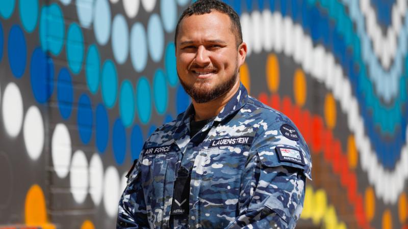 Air Force Indigenous Liaison Officer RAAF Base Darwin, Leading Aircraftman Willhelm Lauenstein, in front of local Indigenous street artwork in Darwin. 