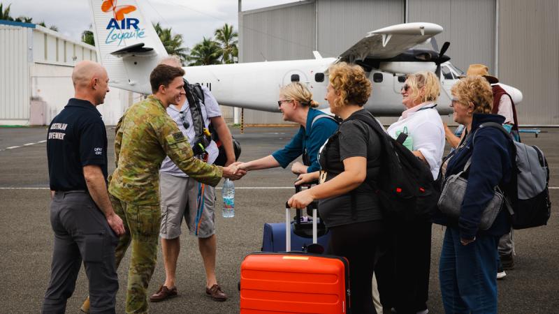 RAAF officer Flight Lieutenant Thomas Rogers from 383 Squadron meets with Australian and other tourists to depart New Caledonia.