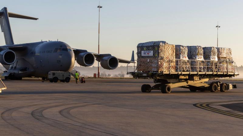 Pallets of aid from Australia and the United Kingdom, bound for Enga Province in Papua New Guinea, are driven out to an awaiting C-17A Globemaster III at RAAF Base Amberley, Queensland. 