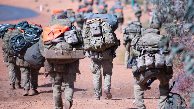 Candidates march with heavy loads during the 2024 Special Forces common selection course.