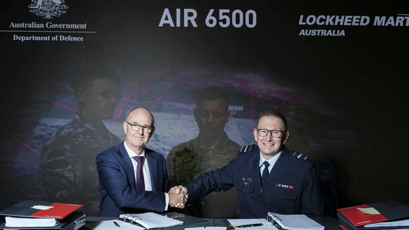 Warren McDonald (left) and Air Vice Marshal David Scheul shake on the head contract. 