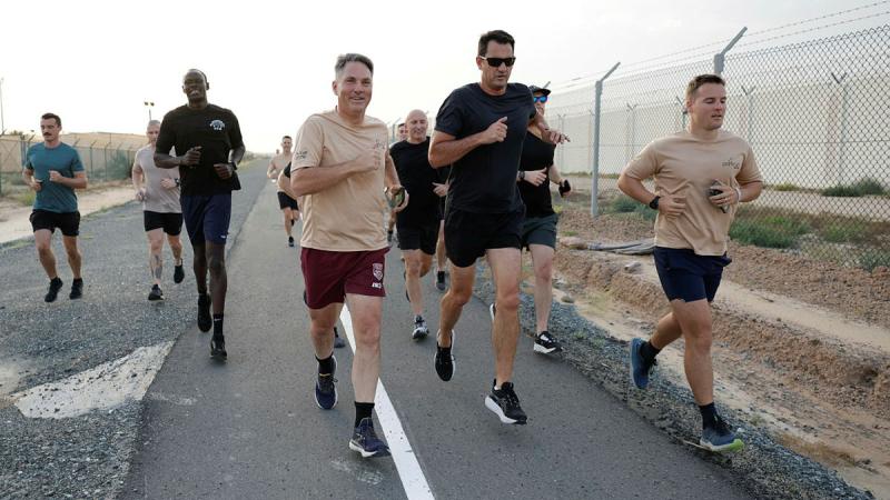 Defence Minister Richard Marles (centre) runs with Australian soldiers in the Middle East. 