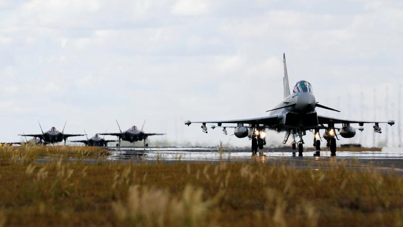 A Luftwaffe Air Force Eurofighter Typhoon taxis towards the runway with RAAF F-35A Lightning II aircraft during Exercise Pitch Black 22. 