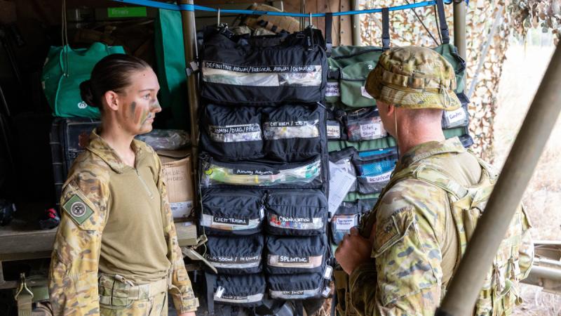(L-R) Australian Army soldier medical technician Private Ashley Taylor and Australian Army medical officer Captain Ryan Broad from the 4th Health Battalion inspect roll bags at the Role 1 Light Manoeuvre on Exercise Brolga Run at Townsville Field Training Area