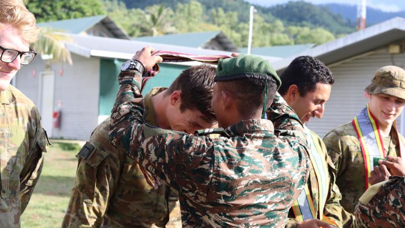 Australian Army soldiers receive a Tais from the Timor-Leste Defence Force members they trained during the farewell ceremony. Photos: Sapper Daniel Bernard-Smith.