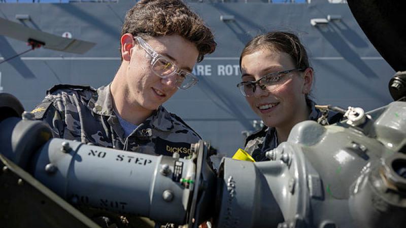 Royal Australian Navy gap year sailors, Seaman Oscar Dickson and Jessica Barnes inspect an MH-60R-Seahawk aboard HMAS Adelaide. 