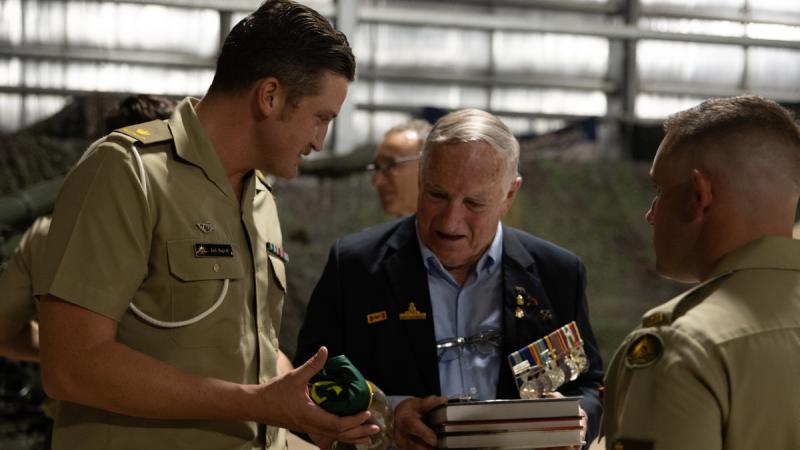 Warrant Officer Class Two (Retired) Ken Murphy is presented a 101 Battery Flag by Battery Commander, Major Jack Bagwill, during a visit to the Regiment on Robertson Barracks, NT.