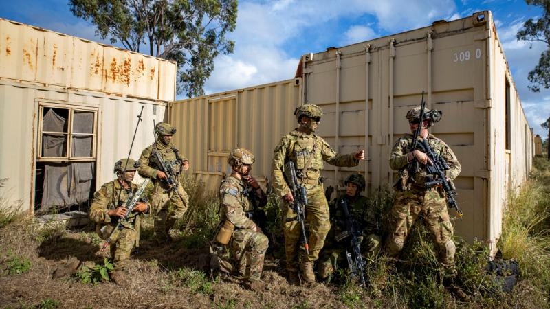 Commanding Officer of 1st Battalion, The Royal Australian Regiment Lieutenant Colonel Brent Hughes works alongside soldiers from United States Army and Japanese Ground Self-Defense Force during an assault at the urban operations training facility on Exercise Brolga Run.