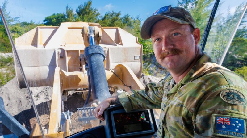 Army plant operator Lance Corporal Samuel Young with some of the heavy plant equipment being used to build barriers to be used in the safe disposal of Explosive Remnants of War during Operation Render Safe in Nauru.