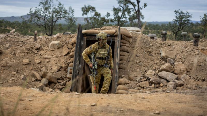 An Army soldier exits the underground command post bunker during Exercise Brolga Run at Townsville Field Training Area, Queensland.