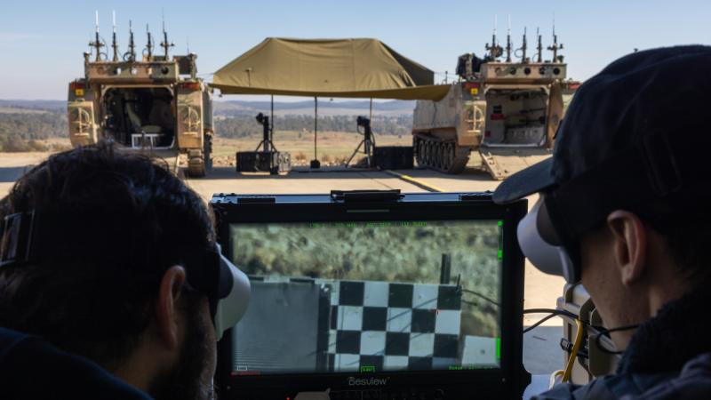 AIM Defence employees operate the AIM Defence Counter-UAS Directed Energy Weapons System during a demonstration at the Puckapunyal Military Area, Victoria.