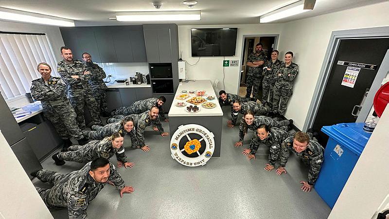 Members from the Maritime Geospatial Warfare Unit complete push-ups before enjoying the Push-Up Challenge morning tea. Photo: Leading Seaman Liam McCauley