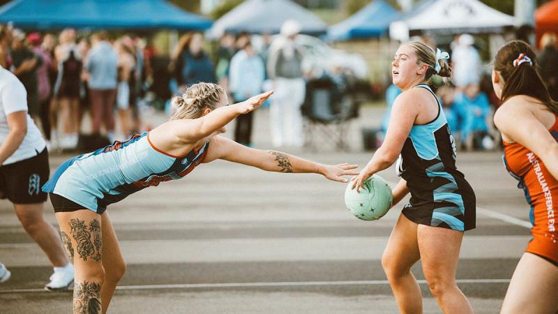 Able Seaman Electronic Warfare Operator Melinda Luke reaches to defend during the NSW State Titles at Camden.