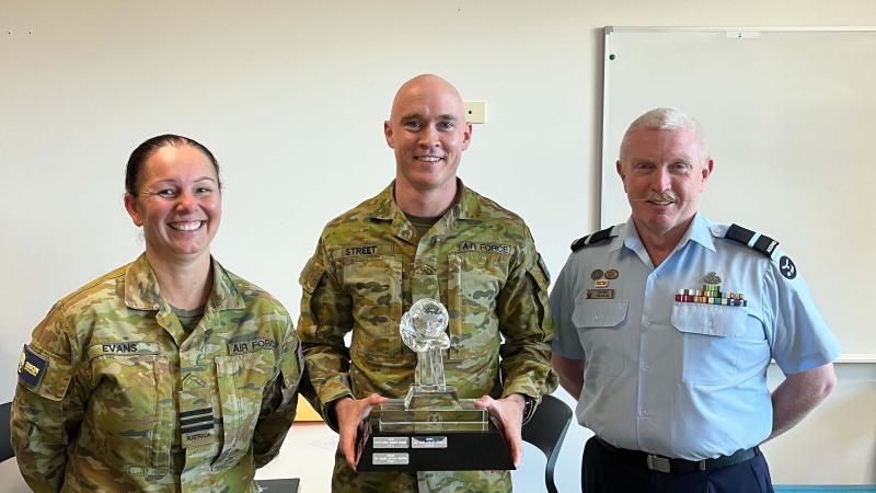 Leading Aircraftman Paul Street (centre) receives the CSG Aviator of the Year and bronze commendation for his work designing and building the frame for the Health OCU BlueRoom simulator.
