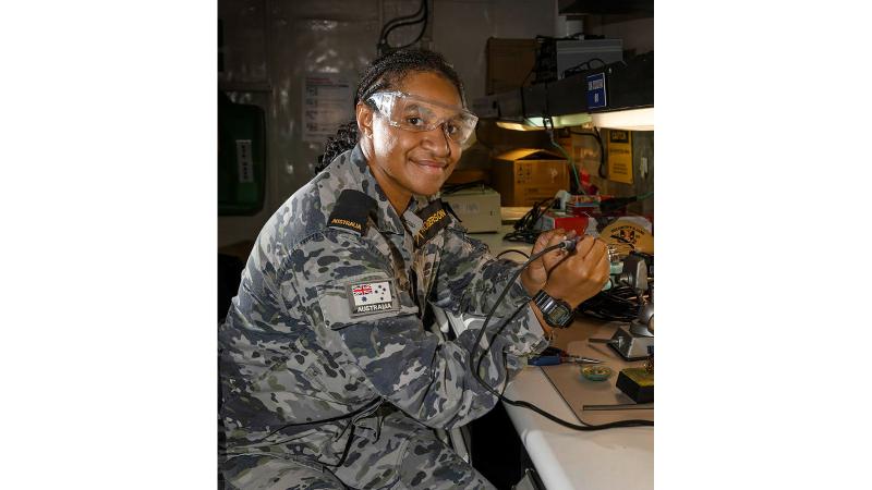 Seaman Electronics Technician Leanne Rogerson conducts maintenance onboard USS Emory S. Land while alongside HMAS Coonawarra, Darwin.