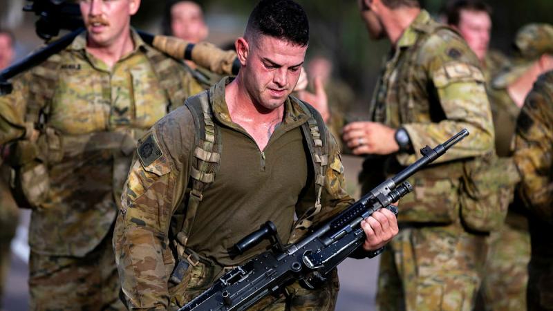 Soldiers from 3rd Battalion, The Royal Australian Regiment participate in a weighted "Gun Run" during a physical training session after several weeks deployed to the field, Lavarack Barracks, Queensland.