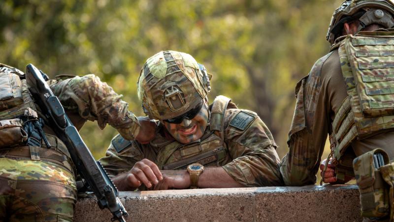 Australian Army troopers from the 2nd/14th Light Horse Regiment (Queensland Mounted Infantry) help a mate over a 10-foot wall, during the 7th Brigade Military Skills Competition at Gallipoli Barracks, Brisbane.