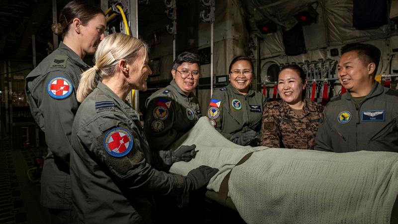Health Operational Conversion Unit Aeromedical Evacuation course director, Flight Lieutenant Di Casey (left) converses with participating international partners inside of a C-130J Hercules training fuselage at RAAF Base Richmond. 