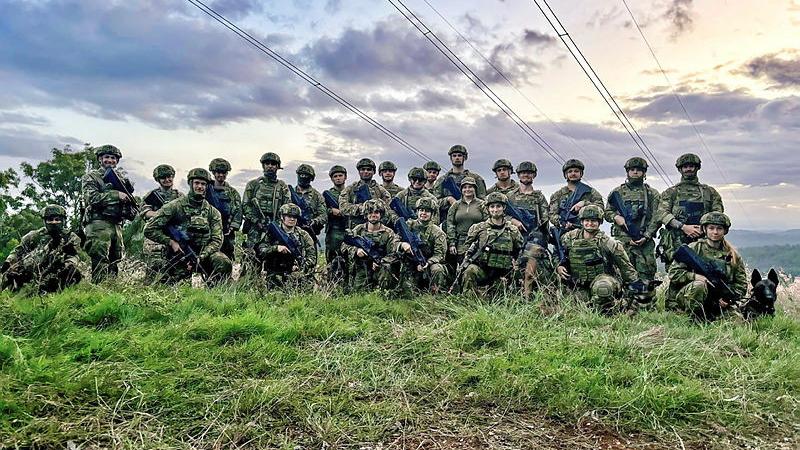 Royal Australian Air Force personnel from No. 23 Squadron gather at the Fernvale Training Area, Queensland during Security Flight training. Photo: Flying Officer Scott Marshall.