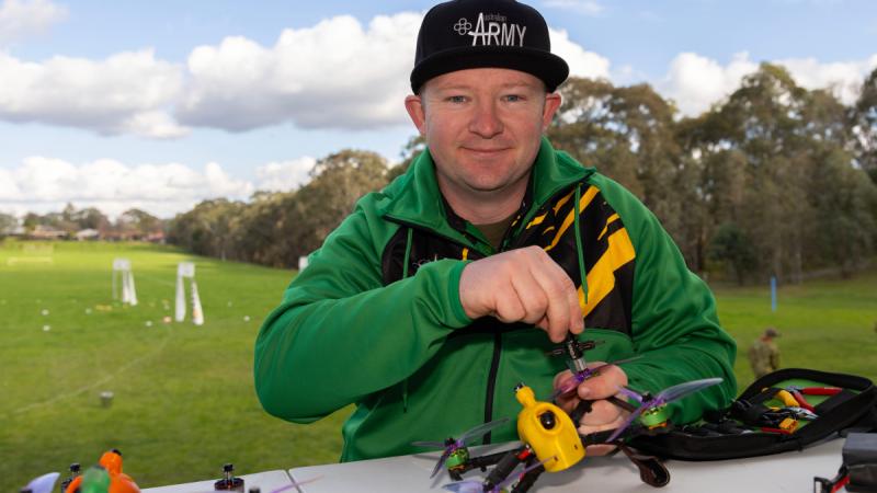  Army soldier, Corporal William Maloney, from the Australian Army Drone Racing Team, works on his drone during the Nationals Qualifier held at Simpson Barracks, Victoria.