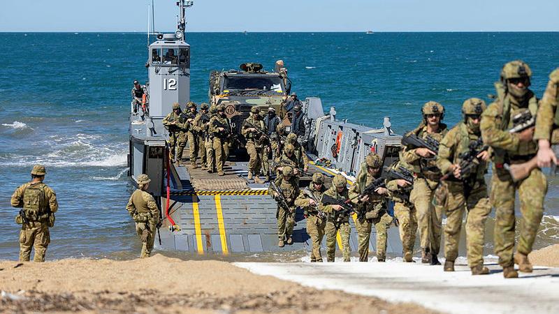 Australian Army soldiers from the Australian Amphibious Force disembark a Littoral Landing Craft during Wet and Dry Environment Rehearsals at Cowley Beach Training Area. 