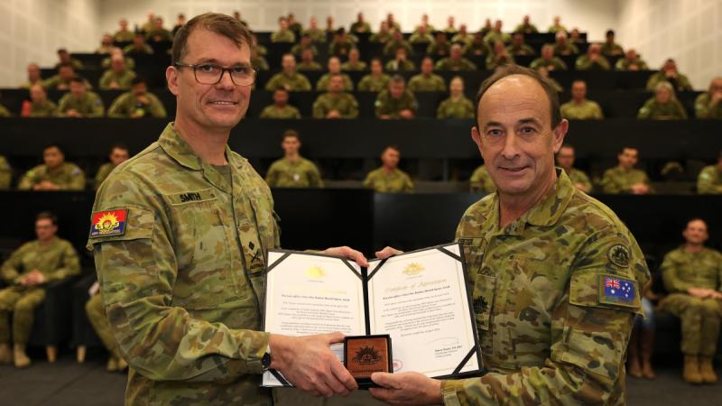  Deputy Chief of Army Major General Christopher Smith presents Warrant Officer Class 1 Rodney Speter with his two Federation Stars for 45 years of service. 