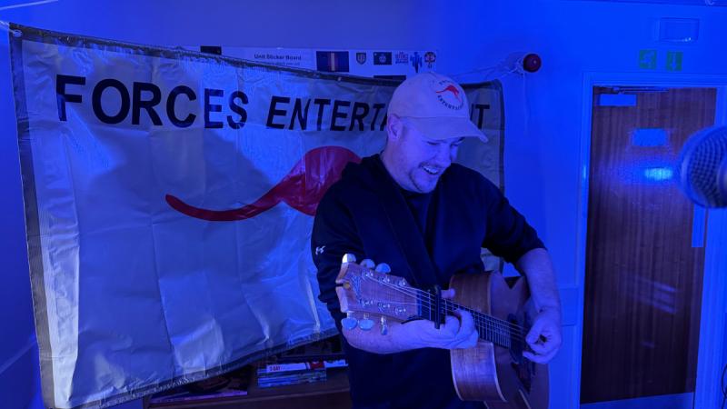 Australian guitarist Glen Harrison gives his all while performing with Australian country music star Amber Lawrence during a Forces Entertainment Tour in the UK. 