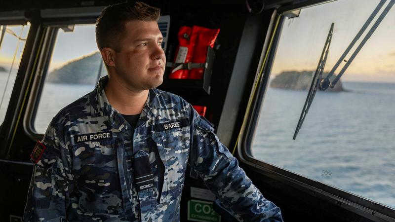 Flight Lieutenant Rory Barrie, of the Australian Space Operations Centre, on the bridge of HMAS Adelaide during an Australian Amphibious Force exercise at Cowley Beach Training Area. 