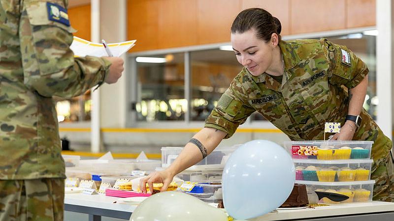 Leading Aircraftwoman Kris Maddison takes a piece of cake to judge during The Cancer Council Australia’s Biggest Morning Tea conducted by 23 Squadron at RAAF Base Amberley, QLD. 