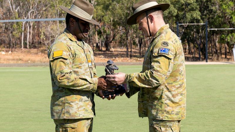 Commander of The 1st Brigade, Brigadier Douglas Pashley, presents an Australian Indigenous Development Program graduate with an award at Defence Establishment Berrima in Darwin. 