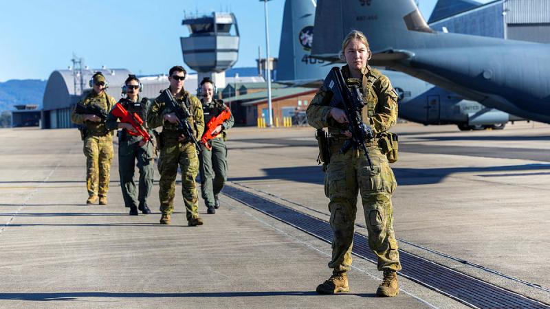 Personnel from 1 Security Forces Squadron, RAAF Base Williamtown, participate in a non-permissive training scenario on the flightline at RAAF Base Richmond. 