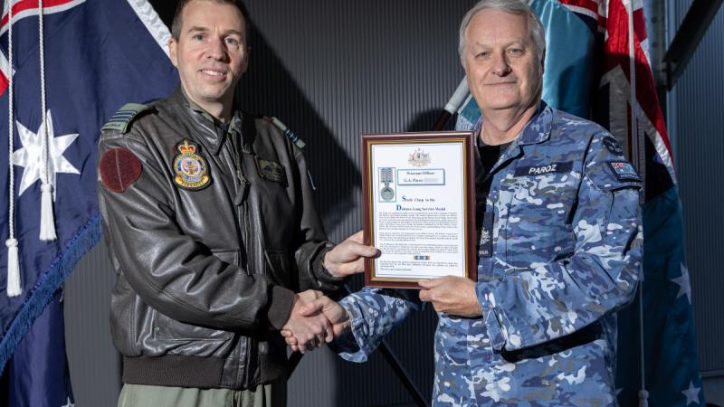 Commanding Officer 37 Squadron Wing Commander Charles Freebairn (L) presents Warrant Officer Graeme Paroz with his second Federation Star, RAAF Base Richmond.