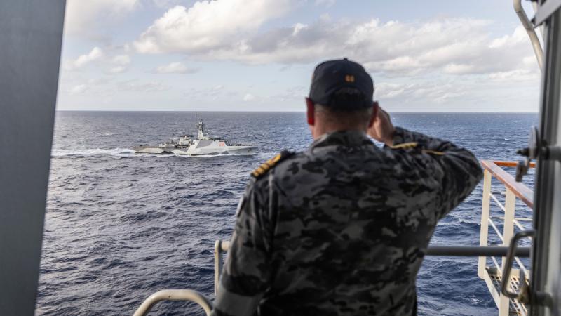 Commanding Officer of HMAS Choules Commander Arron Convery salutes HMS Tamar after successful Officer Of the Watch manoeuvres during cooperative activities while on a regional presence deployment. Photo: Able Seaman Lucinda Allanson.