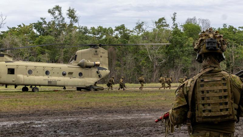 Australian Army soldiers practice offloading from a United States Army Reserve CH-47 Chinook in preparation for an insertion into the Field Training Exercise during Exercise Keris Strike in Sabah, Malaysia. 
