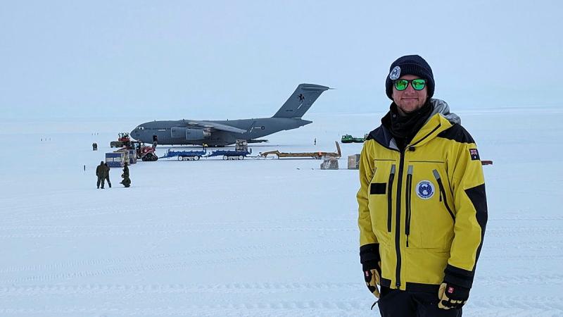 Flying Officer Owen Horton standing in front of a RAAF C-17 at Casey Station, Antarctica.
