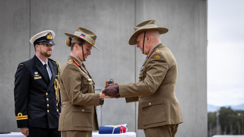 Outgoing Chief of Joint Capabilities Lieutenant General John Frewen presents Chief of Joint Capabilities Lieutenant General Susan Coyle with the symbol of office at the Change of Command ceremony, Russell Offices, Canberra.