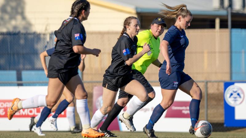  Royal Australian Navy sailor and a United States Marine compete for the ball during a 4th of July soccer match held at Darwin Football Stadium, NT. Photos: Petty Officer Leo Baumgartner.