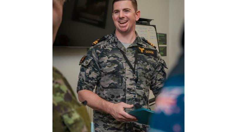 Lieutenant David Gouge talks with other members in the Multi-National Logistics Support Element during Exercise Rim of the Pacific 2024, in Hawaii. 