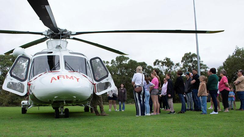 Soldiers present a safety brief to Townsville Hospital Foundation charity recipients on the Army-leased AW139 helicopter.