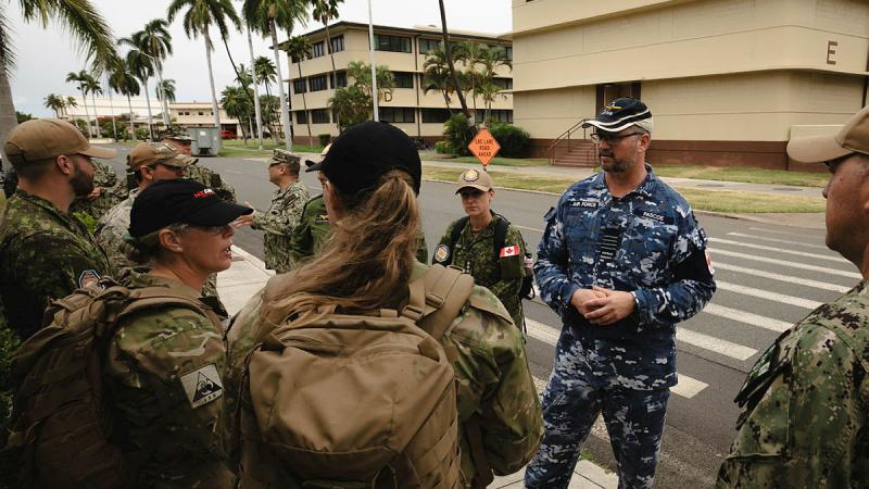 RAAF Group Captain Glenn Pascoe, Surgeon to the Combined Forces Air Component Command (CFACC) at Joint Base Pearl Harbor-Hickam, Hawaii for Exercise RIMPAC 2024, speaks with medical team members.