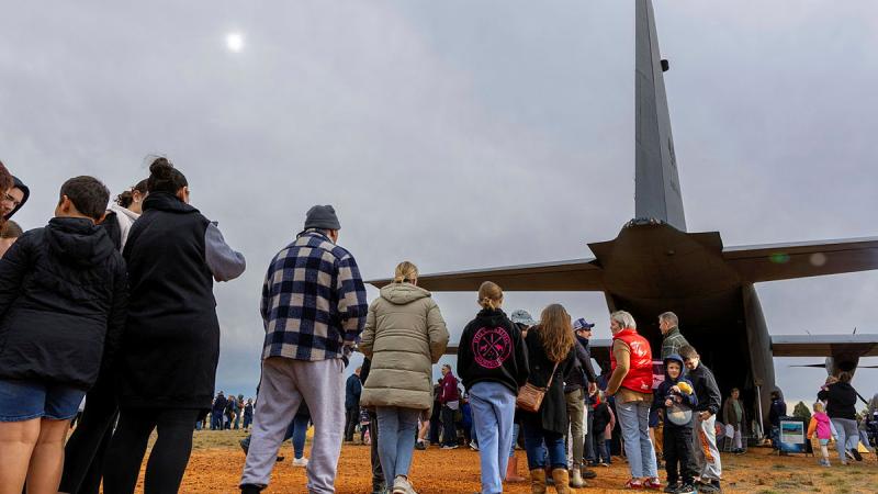 The general public line up to enter a C-130J Hercules as part of a community engagement during NAIDOC Week at Gilgandra, NSW.