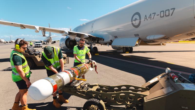 Air Force aviators from 11 Squadron transfer a Mk54 Lightweight exercise torpedo to a RAAF P-8A Poseidon during Exercise Rim of the Pacific 2024, at Joint Base Pearl Harbor-Hickam, Hawaii.